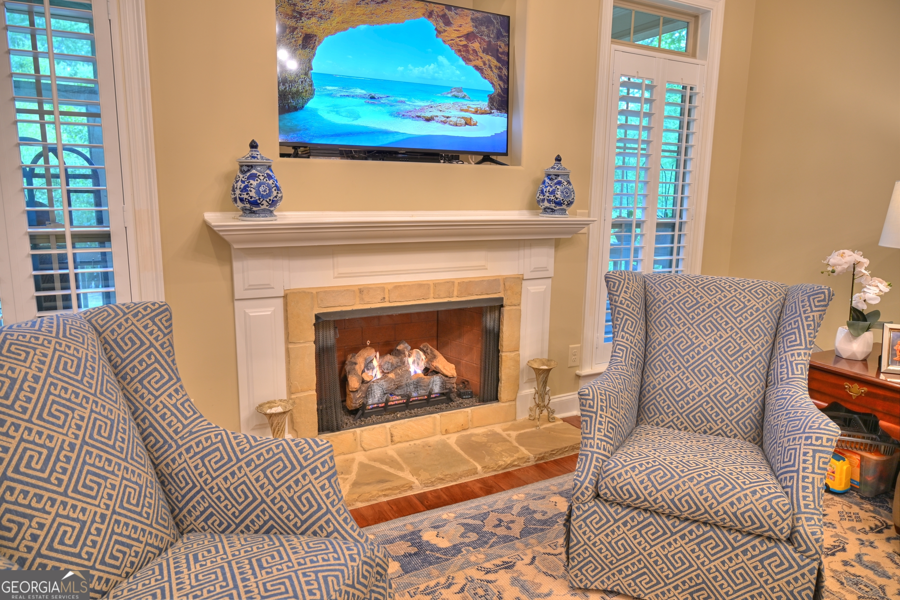7381 Lullwater Road Columbus, GA 31904 - Photo 41 of 47 a living room with furniture a fireplace and a window