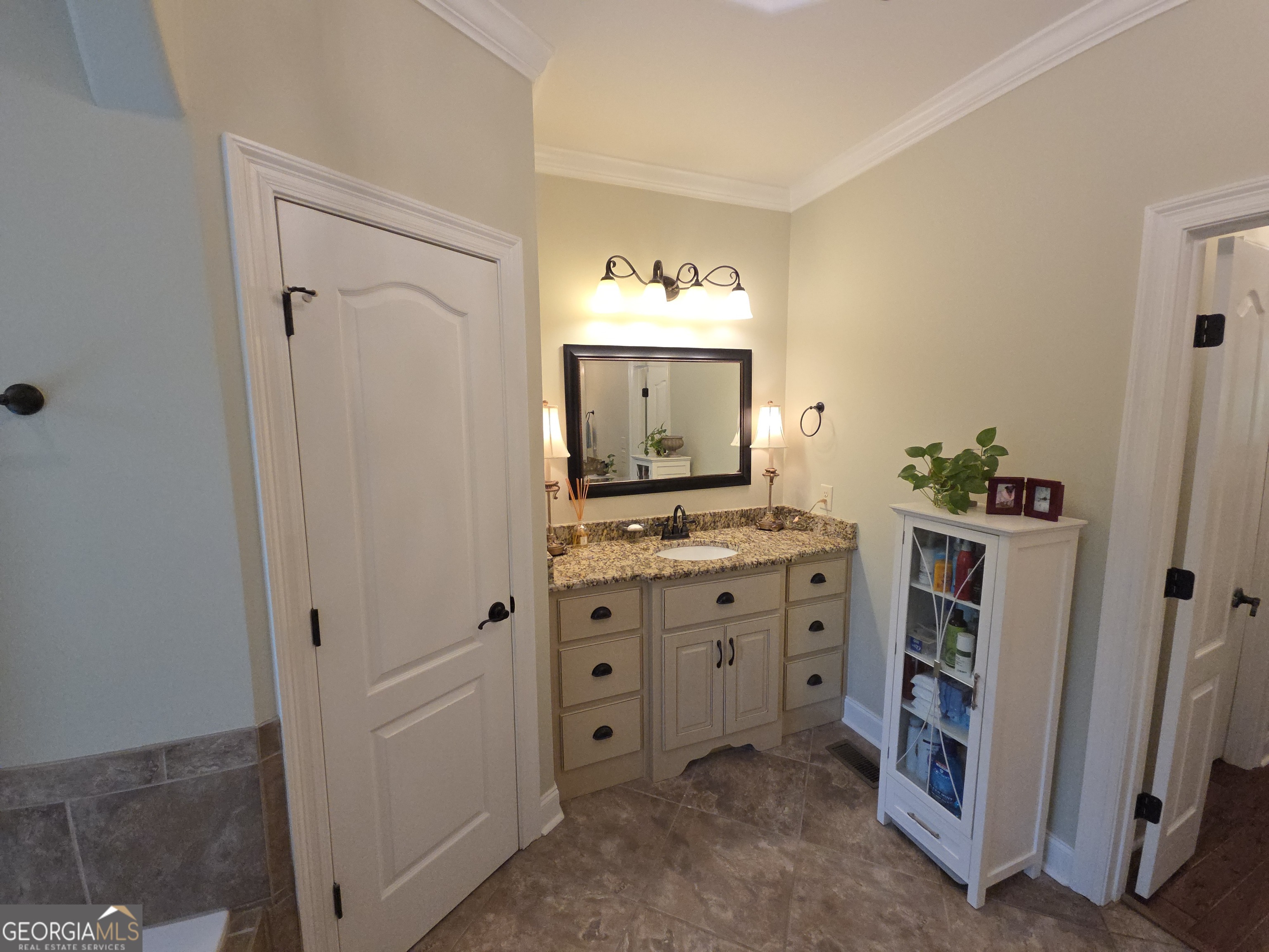 7381 Lullwater Road Columbus, GA 31904 - Photo 6 of 47 a bathroom with a double vanity sink and mirror