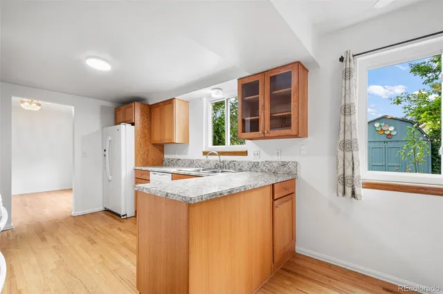a kitchen with stainless steel appliances granite countertop a refrigerator and a sink