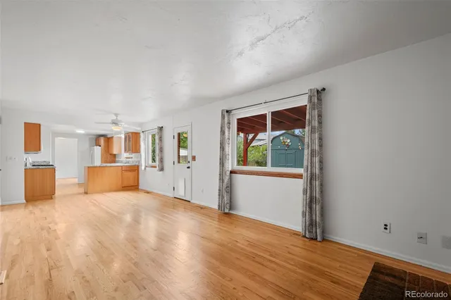 a view of a room with wooden floor and a window
