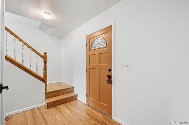 a view of front door with wooden floor