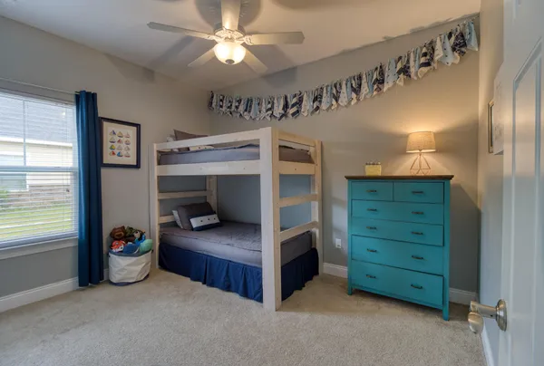 a bedroom with furniture and a window