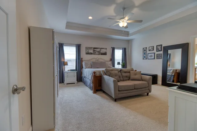 a living room with furniture and a ceiling fan