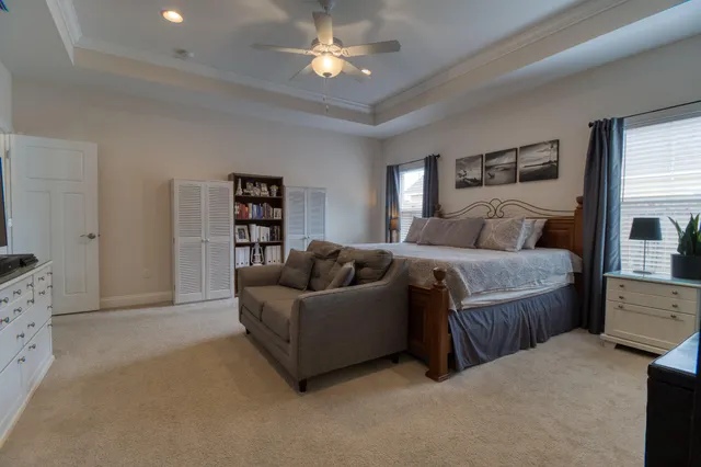 a spacious bedroom with a bed and a couch