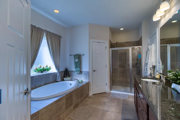 a bathroom with a tub and shower