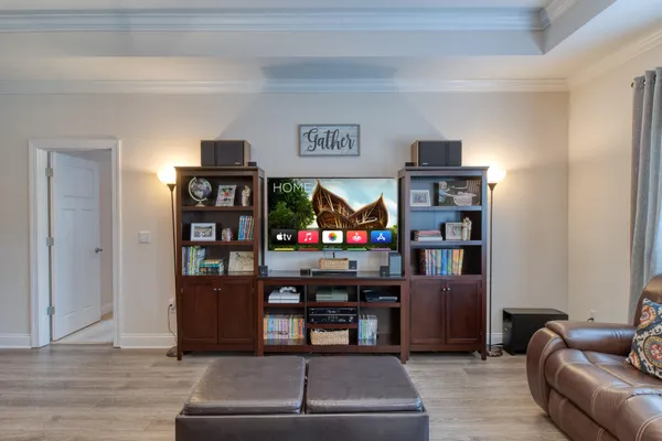 a living room with furniture cabinets and window