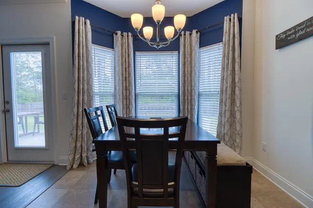 a view of a dining room with furniture and window