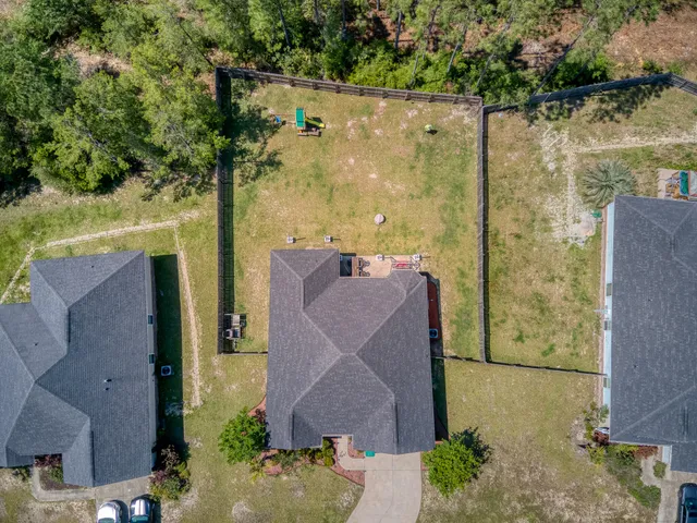 an aerial view of a house with a yard