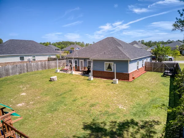 a front view of a house with a garden and lake view