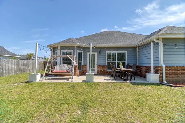 a view of a house with backyard porch and sitting area