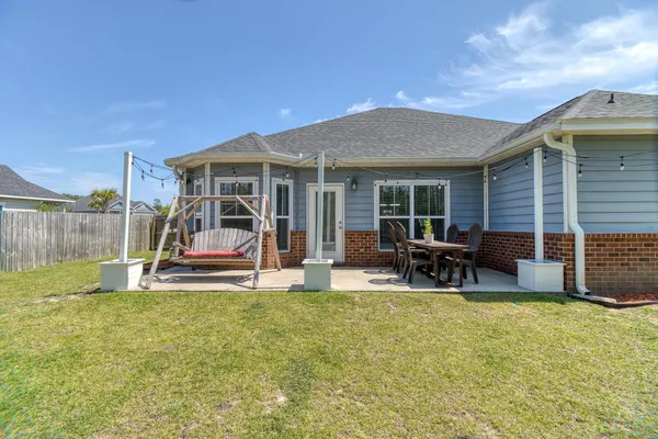 a view of a house with backyard porch and sitting area