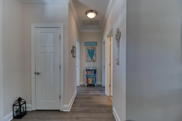 a view of a hallway with wooden shelves