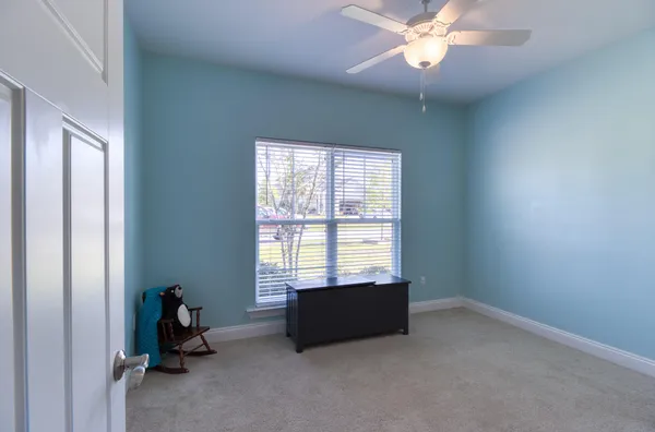 a room with window and ceiling fan
