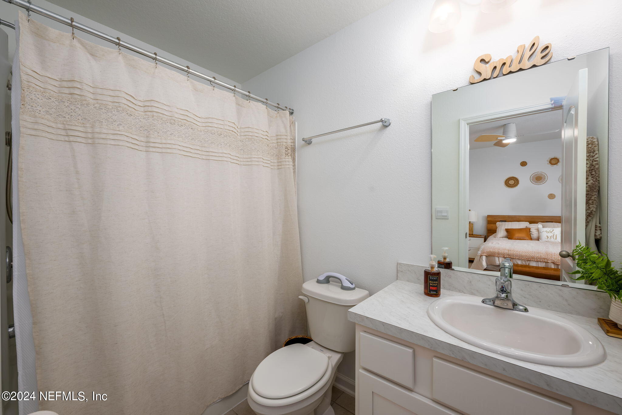 32 Vero Drive St. Augustine, FL 32095 - Photo 19 of 40 a bathroom with a sink a toilet and shower curtain