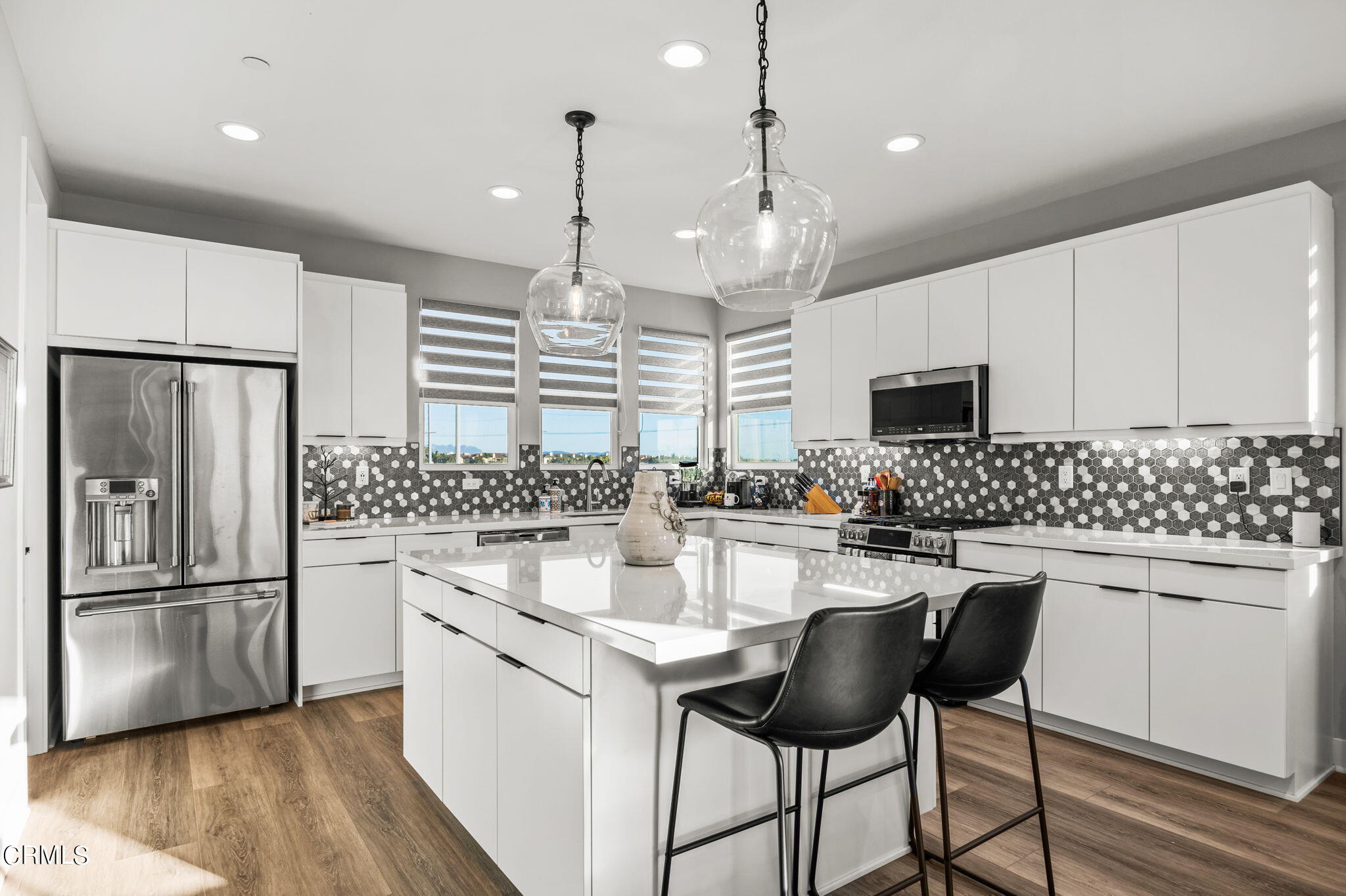 1051 Canal Street Oxnard, CA 93035 - Photo 18 of 54 a kitchen with stainless steel appliances kitchen island a refrigerator a stove a sink and a microwave
