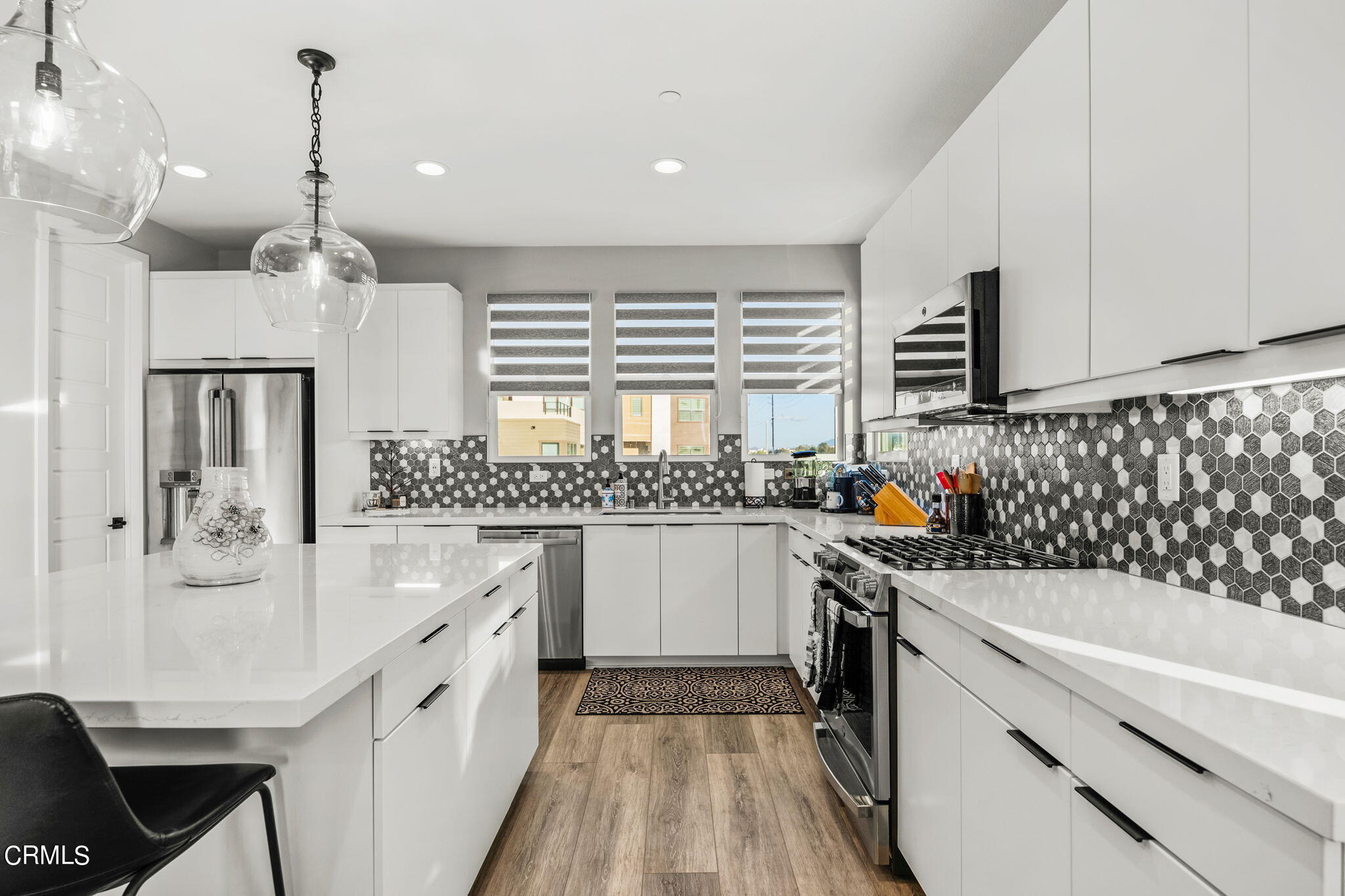1051 Canal Street Oxnard, CA 93035 - Photo 20 of 54 a kitchen with granite countertop a sink stove and refrigerator