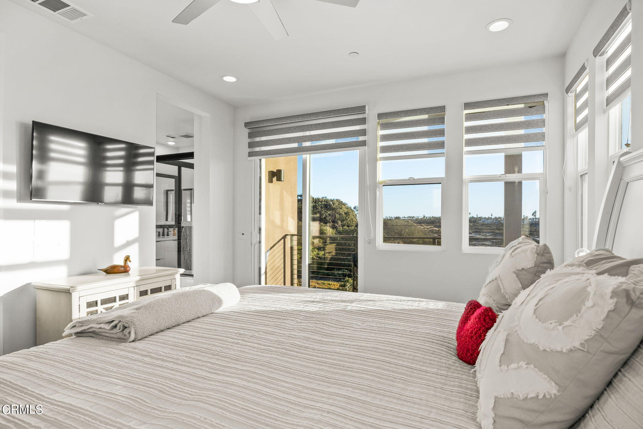 1051 Canal Street Oxnard, CA 93035 - Photo 26 of 54 a bedroom with a bed and wooden floor