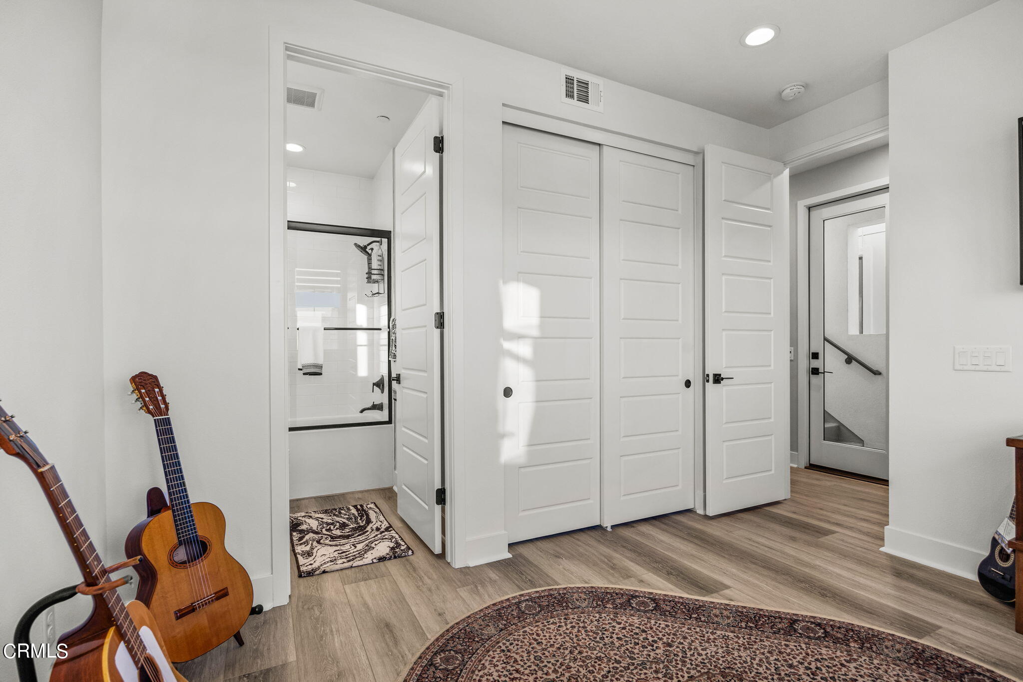 1051 Canal Street Oxnard, CA 93035 - Photo 34 of 54 a spacious bedroom with a bed and wooden floor