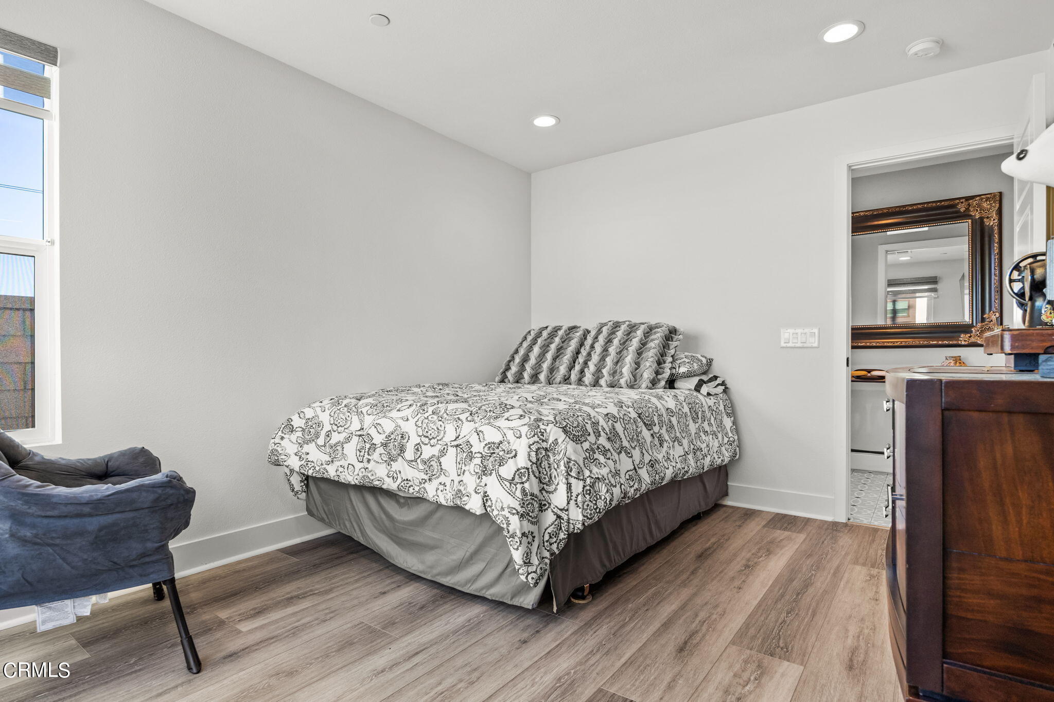 1051 Canal Street Oxnard, CA 93035 - Photo 39 of 54 a bedroom with a bed and wooden floor