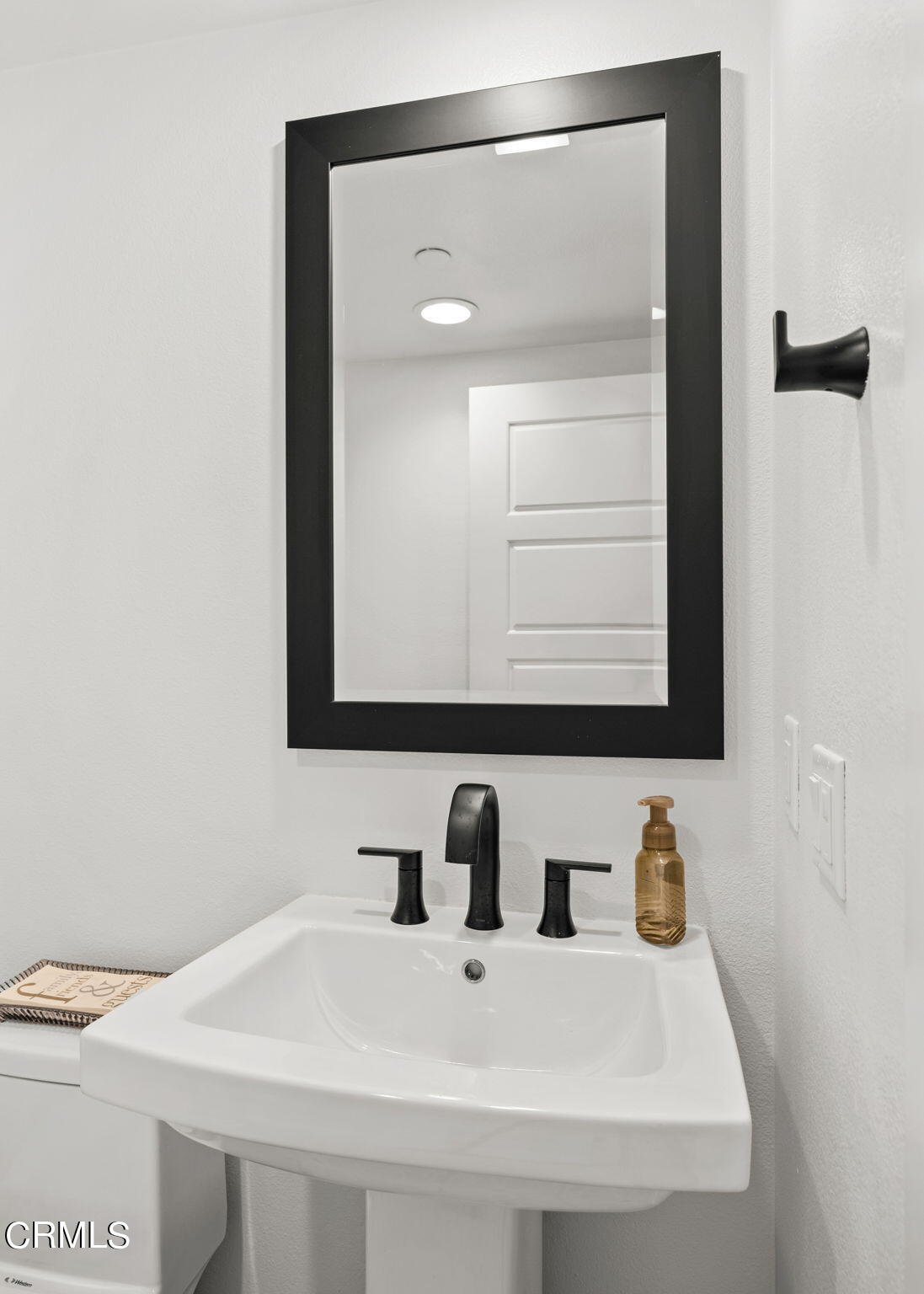 1051 Canal Street Oxnard, CA 93035 - Photo 44 of 54 a bathroom with a sink and a mirror