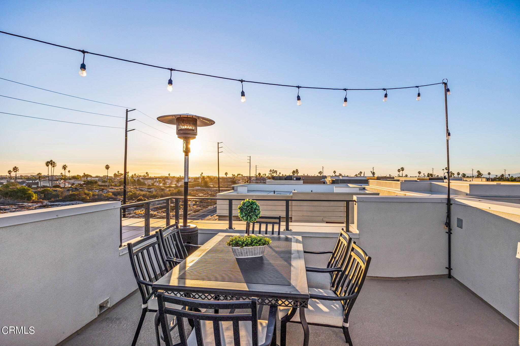 1051 Canal Street Oxnard, CA 93035 - Photo 47 of 54 a view of a roof deck with table and chairs