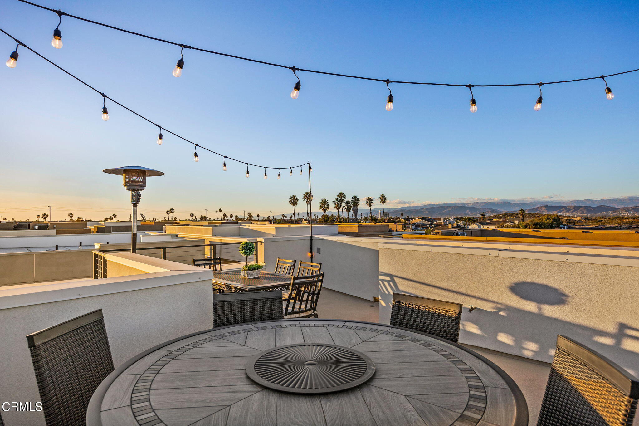 1051 Canal Street Oxnard, CA 93035 - Photo 48 of 54 a kitchen with a table chairs stove and sink