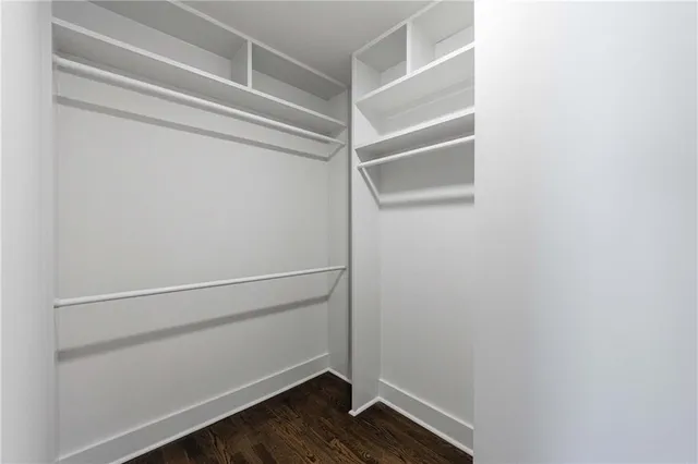 a bathroom with a double vanity sink toilet and shower