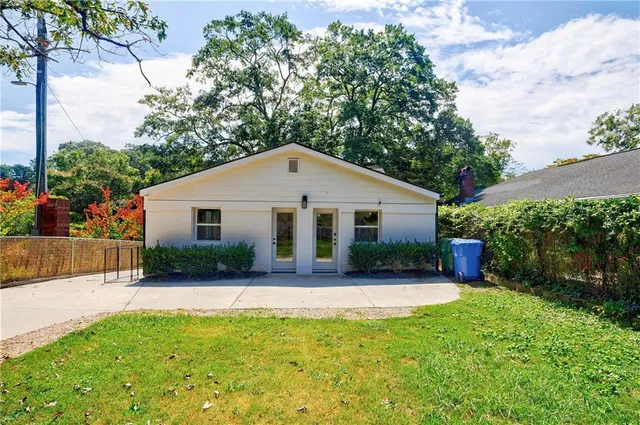 a front view of house with yard and green space