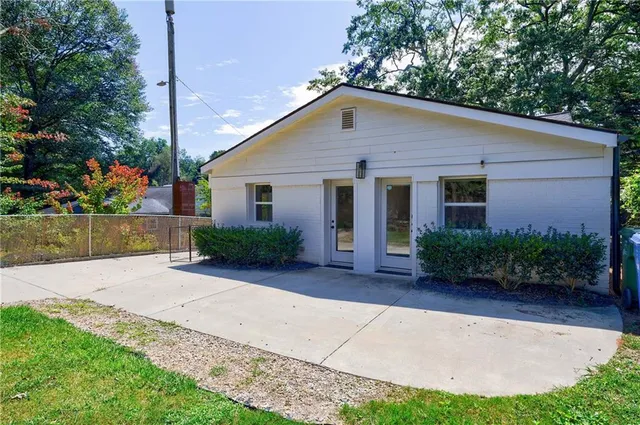 a front view of house with yard and trees