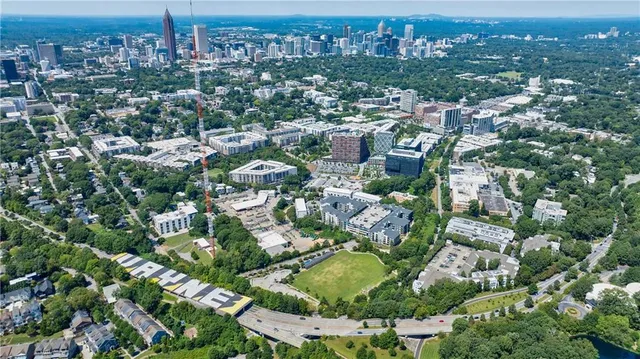 an aerial view of residential houses with outdoor space and trees
