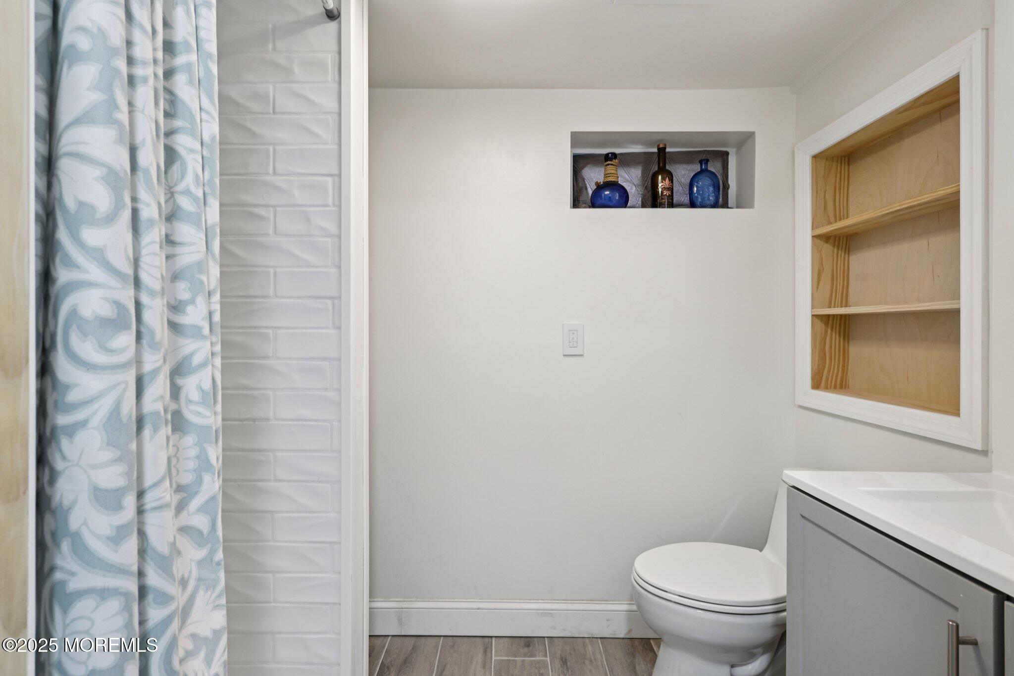 3 Duke Lane Hazlet, NJ 07730 - Photo 15 of 50 a white toilet sitting next to a shower curtain