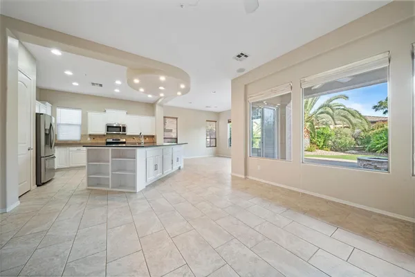 a view of kitchen with kitchen island granite countertop lots of counter space cabinets and stainless steel appliances