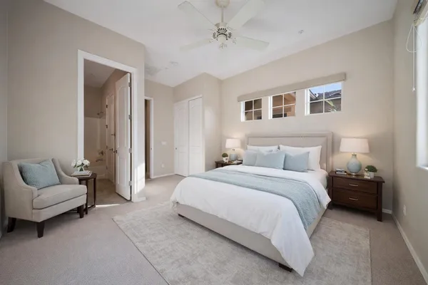a spacious bedroom with a bed and a couch