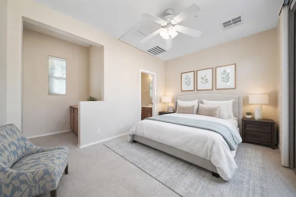 a spacious bedroom with a bed and a couch