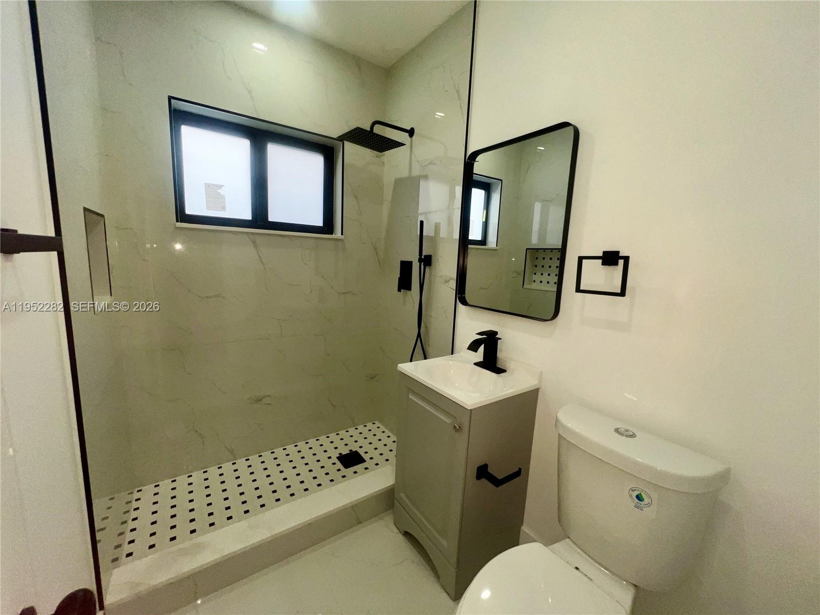 3297 Southwest 26th Street, Unit 3297 Miami, FL 33133 - Photo 15 of 20 a bathroom with a sink toilet and shower