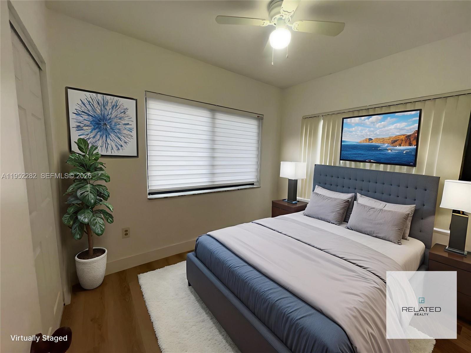 3297 Southwest 26th Street, Unit 3297 Miami, FL 33133 - Photo 16 of 20 a bedroom with a large bed and a potted plant