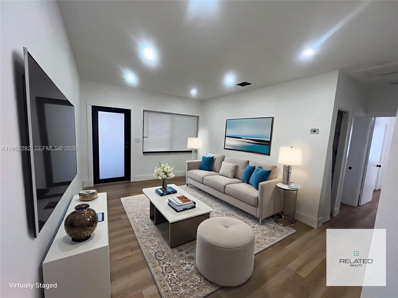 3297 Southwest 26th Street, Unit 3297 Miami, FL 33133 - Photo 18 of 20 a living room with furniture a flat screen tv and a couch