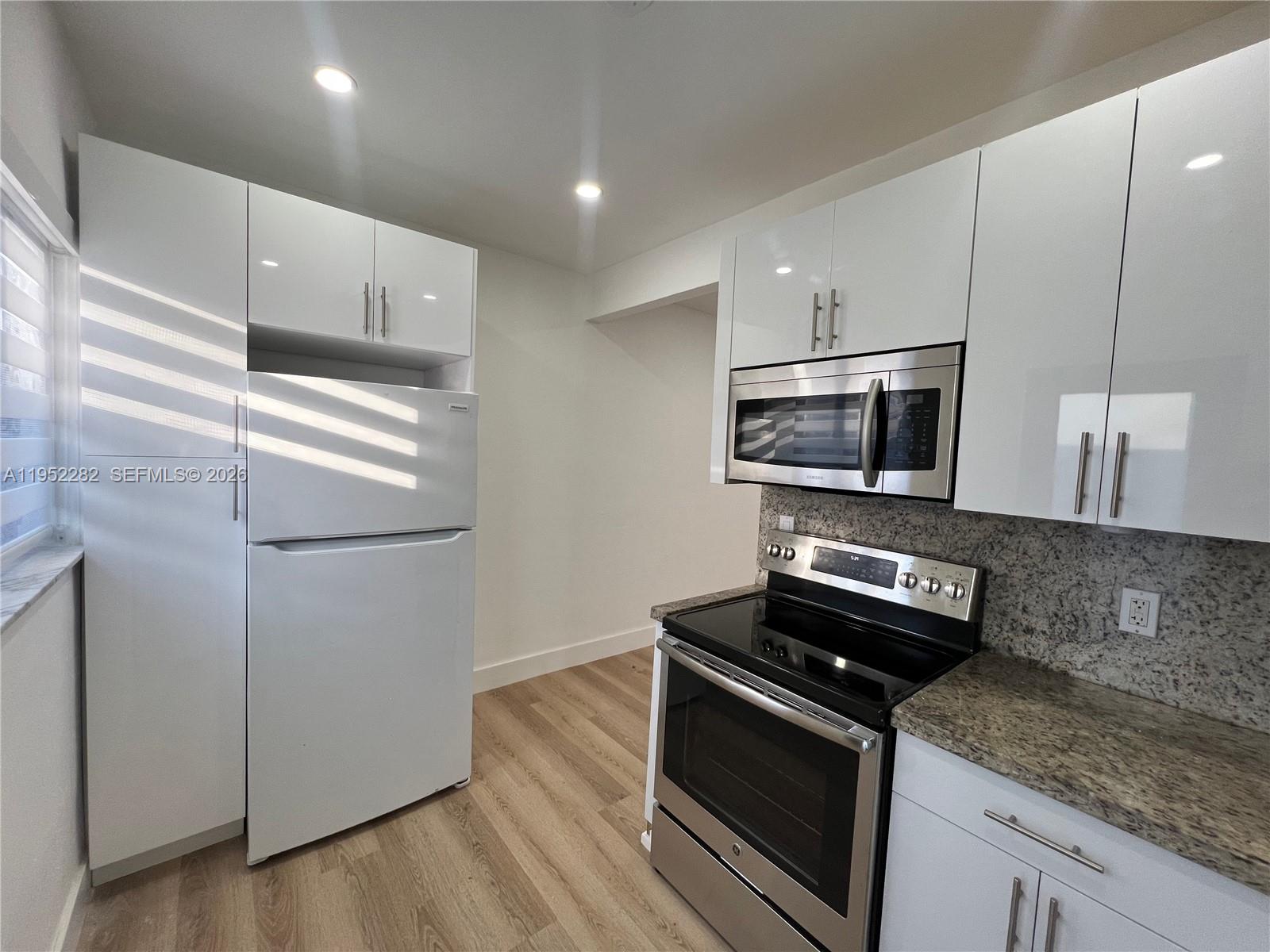 3297 Southwest 26th Street, Unit 3297 Miami, FL 33133 - Photo 6 of 20 a kitchen with a refrigerator stove and microwave