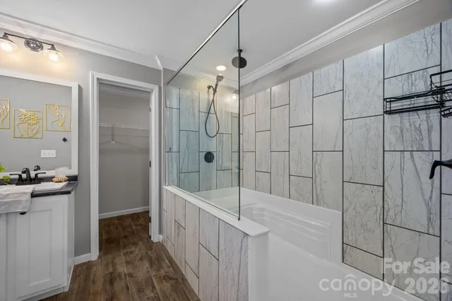 an empty room with a window and a ceiling fan