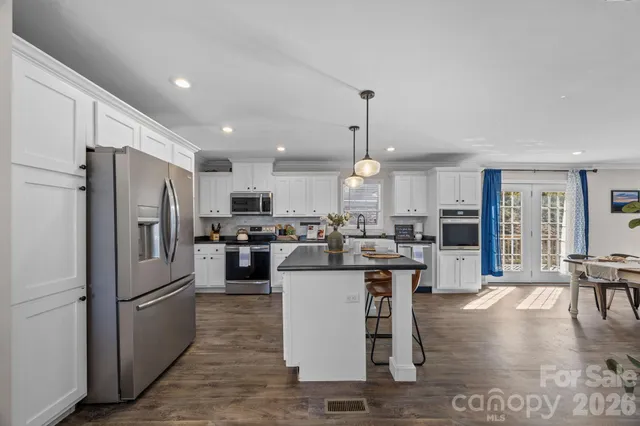 a view of a dining room with furniture and window