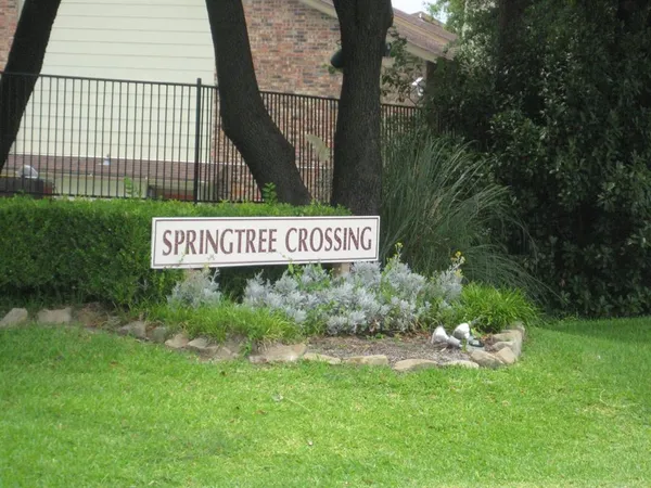a sign that is sitting in the grass of the house
