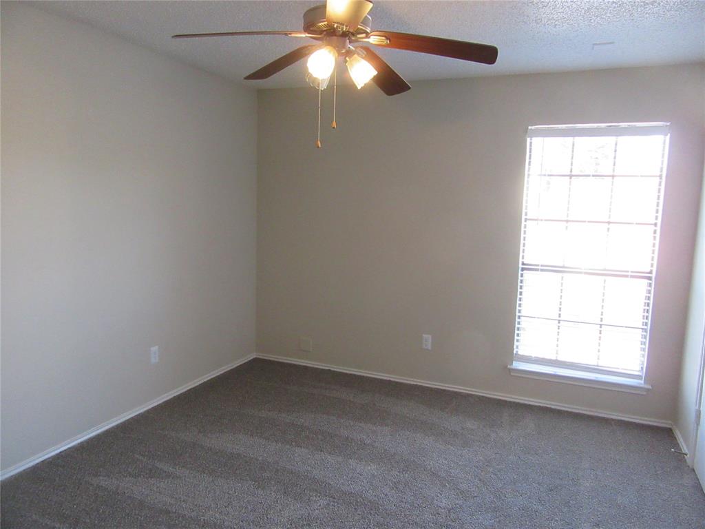 11311 Audelia Road, Unit 241 Dallas, TX 75243 - Photo 7 of 11 an empty room with a window and a fan