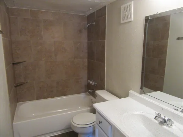 a bathroom with a toilet a sink and bathtub