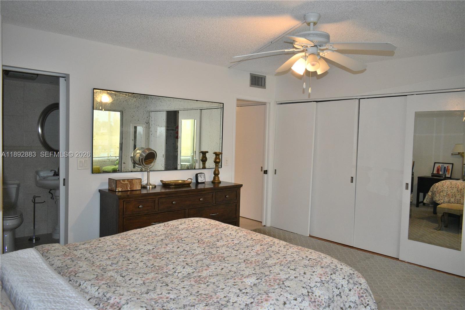 2011 Cornwall East, Unit A Boca Raton, FL 33434 - Photo 11 of 19 a bedroom with a bed and a mirror
