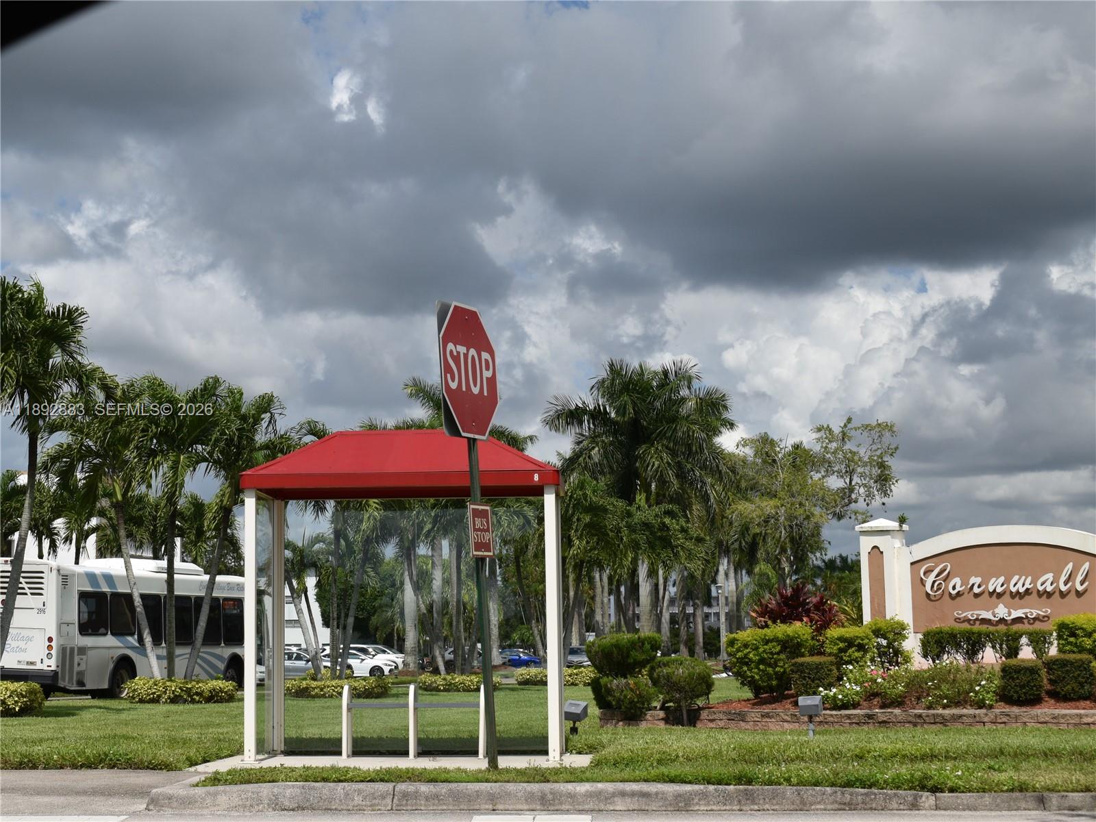 2011 Cornwall East, Unit A Boca Raton, FL 33434 - Photo 18 of 19 a front view of a house with a yard and potted plants