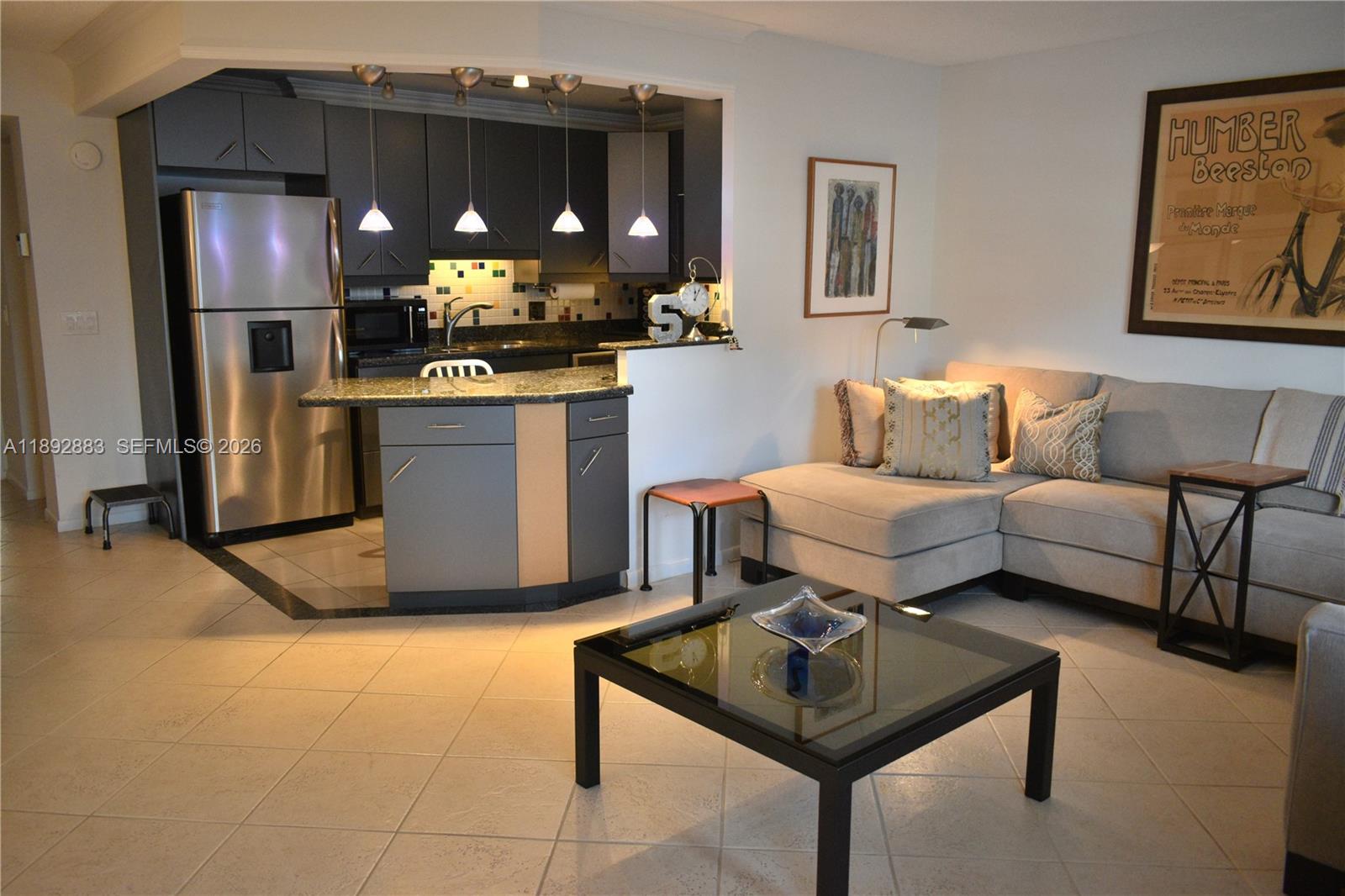 2011 Cornwall East, Unit A Boca Raton, FL 33434 - Photo 2 of 19 a living room with a couch and kitchen view