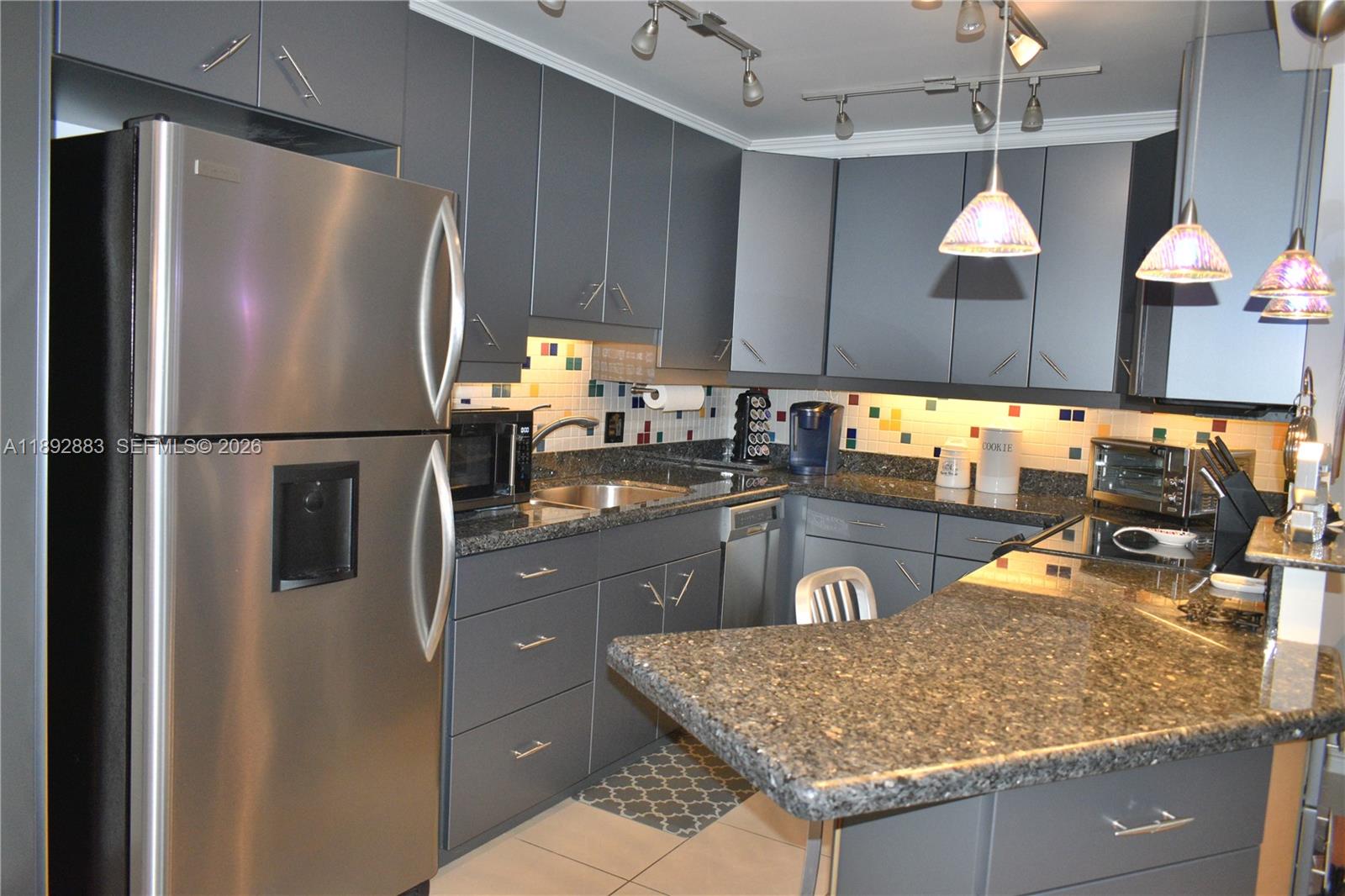 2011 Cornwall East, Unit A Boca Raton, FL 33434 - Photo 3 of 19 a kitchen with stainless steel appliances granite countertop a refrigerator a sink and a stove