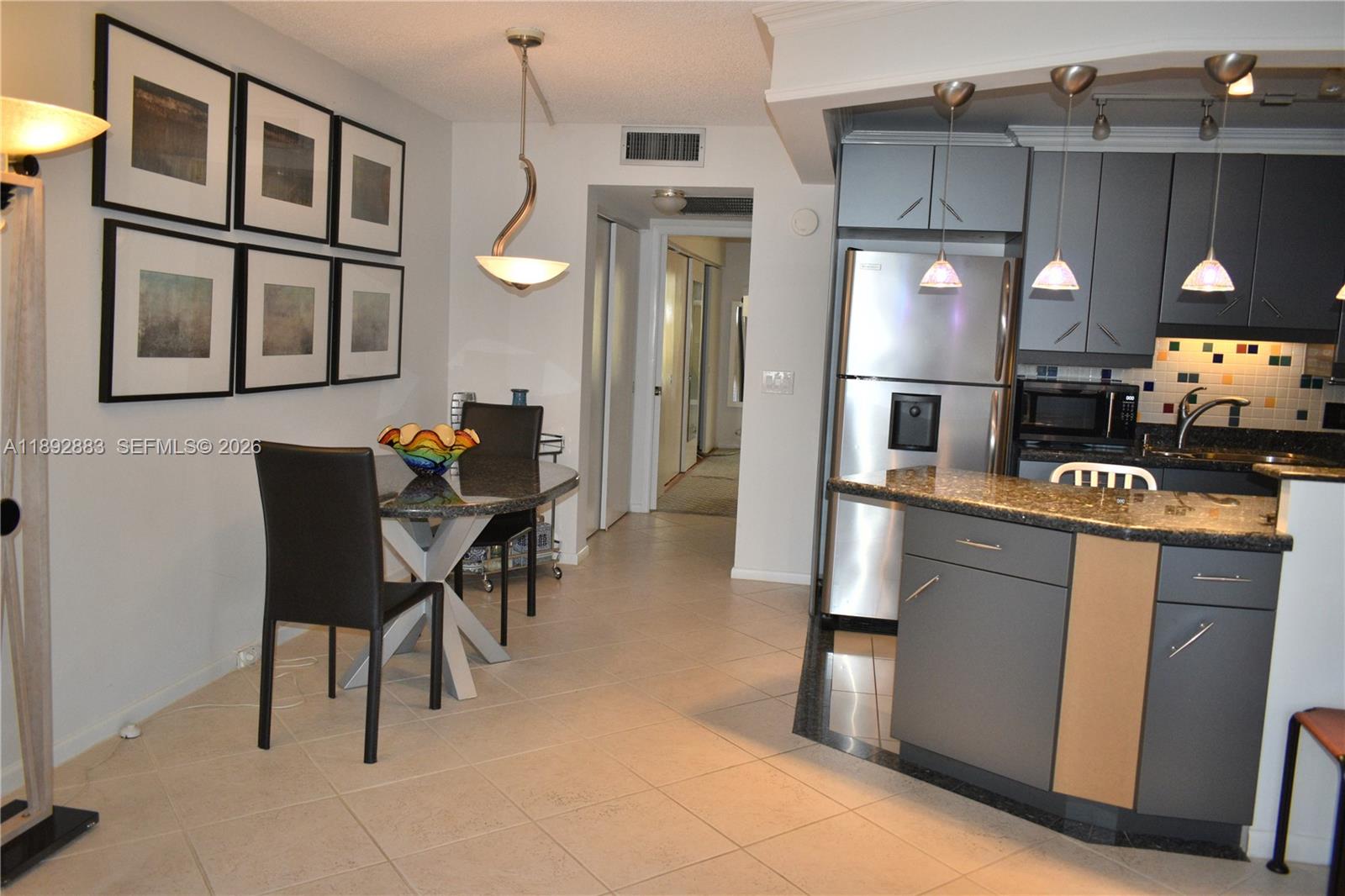 2011 Cornwall East, Unit A Boca Raton, FL 33434 - Photo 6 of 19 a kitchen with cabinets and chairs