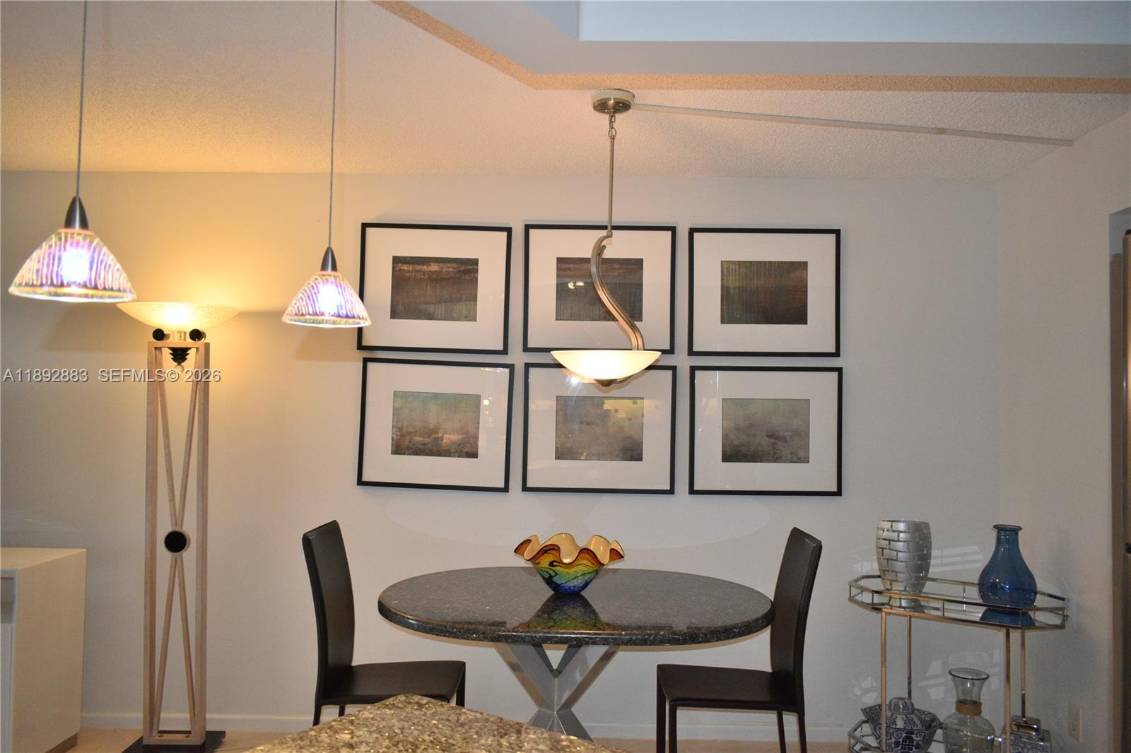 2011 Cornwall East, Unit A Boca Raton, FL 33434 - Photo 7 of 19 a view of a dining room with furniture and chandelier