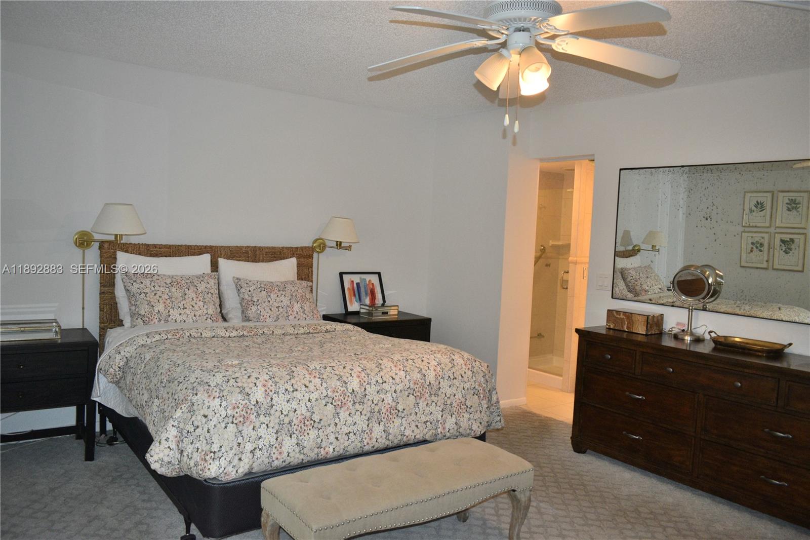 2011 Cornwall East, Unit A Boca Raton, FL 33434 - Photo 9 of 19 a bedroom with a bed and a chandelier